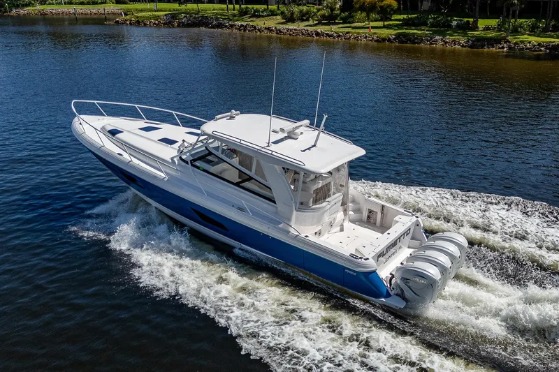  Yacht Photos Pics 2020 Intrepid 477 Evolution boat cruising on a calm river.