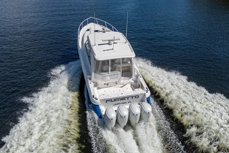  Yacht Photos Pics 2020 Intrepid 477 Evolution boat cruising on water with four outboard engines.