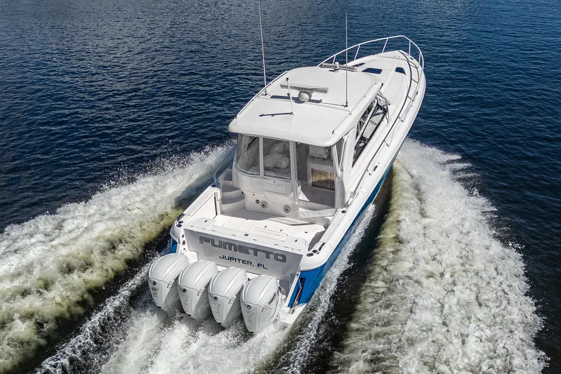  Yacht Photos Pics 2020 Intrepid 477 Evolution boat cruising on water with four outboard engines.