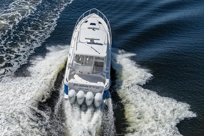  Yacht Photos Pics 2020 Intrepid 477 Evolution boat cruising on water, aerial view.