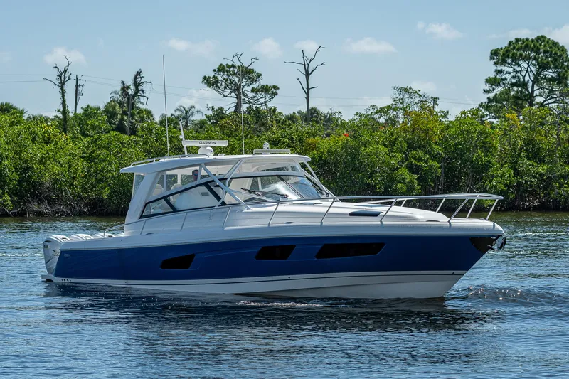  Yacht Photos Pics 2020 Intrepid 477 Evolution boat cruising on a calm river.