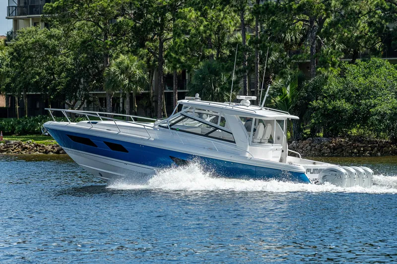  Yacht Photos Pics 2020 Intrepid 477 Evolution boat cruising on a lake.
