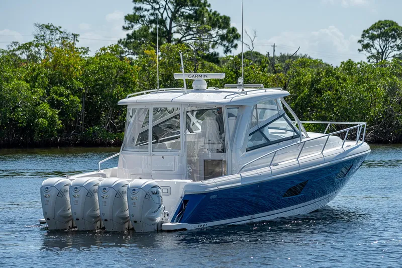 Yacht Photos Pics 2020 Intrepid 477 Evolution boat with four engines on a calm waterway.
