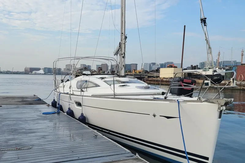  Yacht Photos Pics 2008 Jeanneau Sun Odyssey 42 DS sailboat docked at a marina with city skyline.