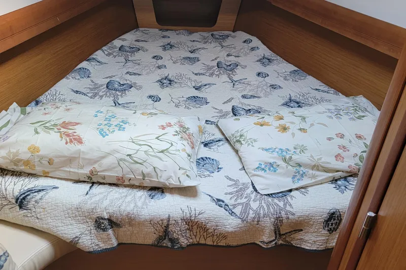  Yacht Photos Pics Cozy cabin bed in 2008 Jeanneau Sun Odyssey 42 DS with floral bedding.