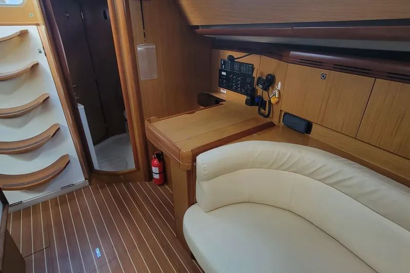  Yacht Photos Pics Interior of 2008 Jeanneau Sun Odyssey 42 DS yacht with wood finish and seating area.