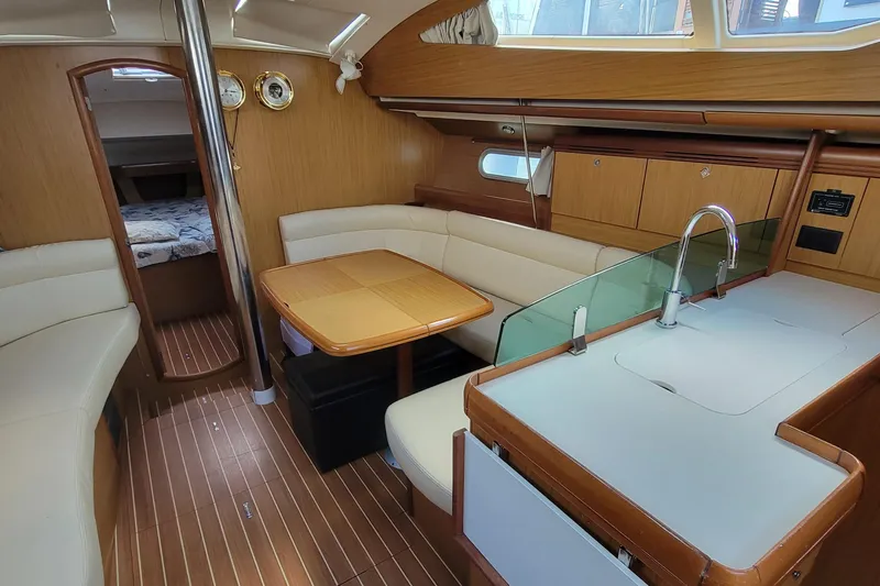  Yacht Photos Pics Interior of 2008 Jeanneau Sun Odyssey 42 DS sailboat with modern wood finish.
