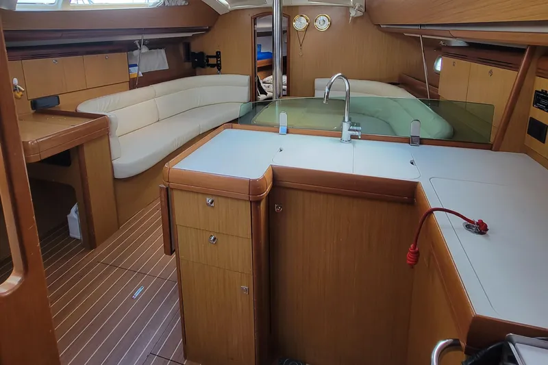  Yacht Photos Pics Interior of 2008 Jeanneau Sun Odyssey 42 DS sailboat with modern kitchen and seating area.