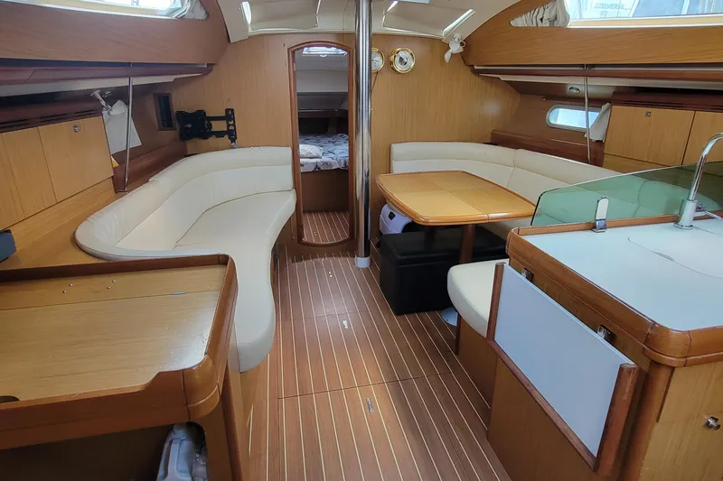  Yacht Photos Pics Interior of 2008 Jeanneau Sun Odyssey 42 DS yacht with elegant wood finish and seating area.