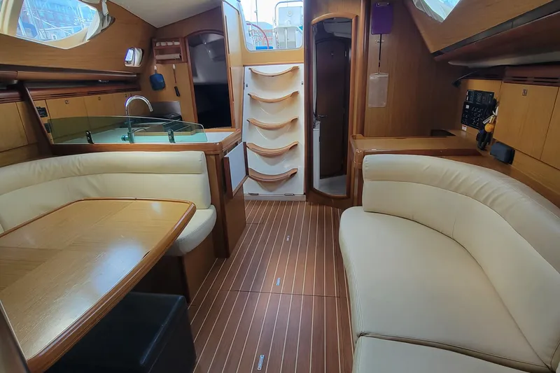  Yacht Photos Pics Interior of 2008 Jeanneau Sun Odyssey 42 DS sailboat with elegant wood finish and seating.