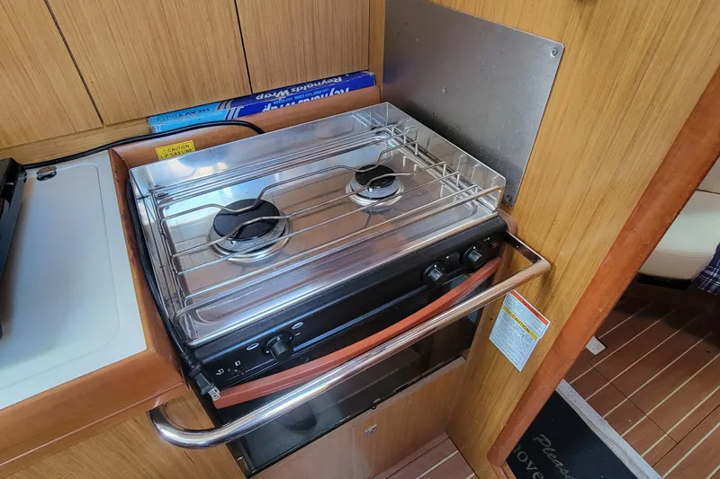  Yacht Photos Pics Compact kitchen stove in 2008 Jeanneau Sun Odyssey 42 DS yacht interior.