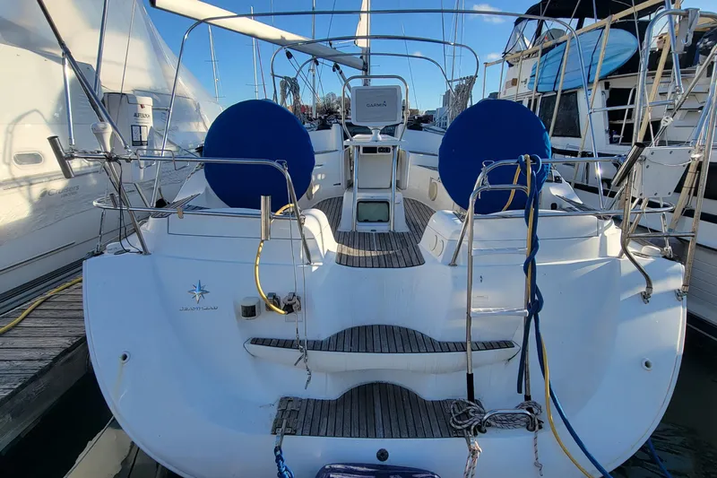  Yacht Photos Pics 2008 Jeanneau Sun Odyssey 42 DS sailboat docked, featuring dual steering wheels and spacious cockpit.