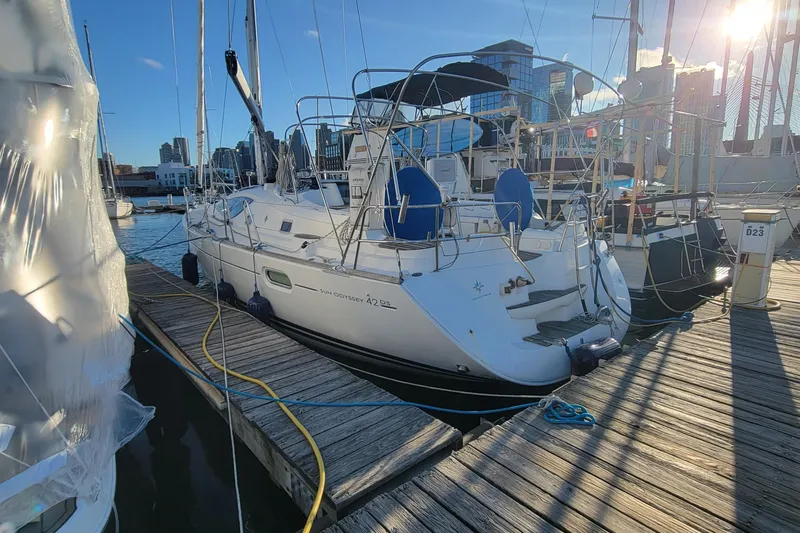  Yacht Photos Pics 2008 Jeanneau Sun Odyssey 42 DS sailboat docked at marina, sunny day, city skyline.