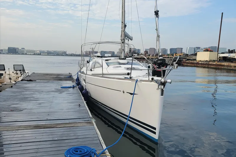  Yacht Photos Pics 2008 Jeanneau Sun Odyssey 42 DS sailboat docked at marina with city skyline.