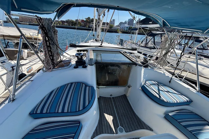  Yacht Photos Pics 2008 Jeanneau Sun Odyssey 42 DS sailboat cockpit with striped cushions and marina view.