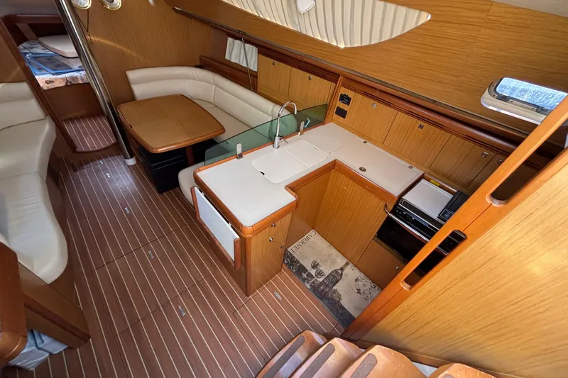  Yacht Photos Pics Interior of 2008 Jeanneau Sun Odyssey 42 DS yacht with kitchen and seating area.