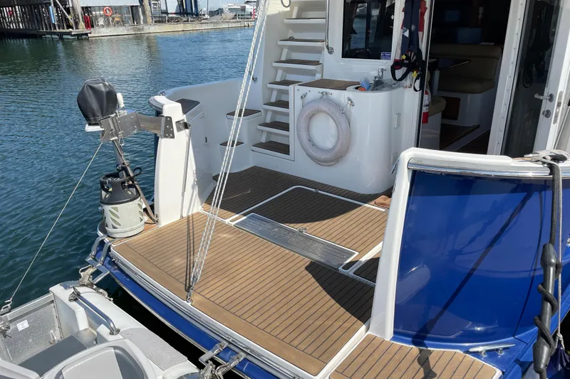  Yacht Photos Pics 2007 Fathom Yachts 40, rear deck view with wooden flooring and marina backdrop.