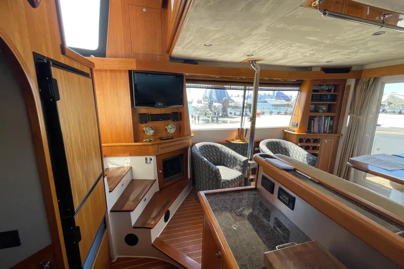  Yacht Photos Pics Luxurious interior of 2007 Fathom Yachts 40, featuring wood finishes and comfortable seating.