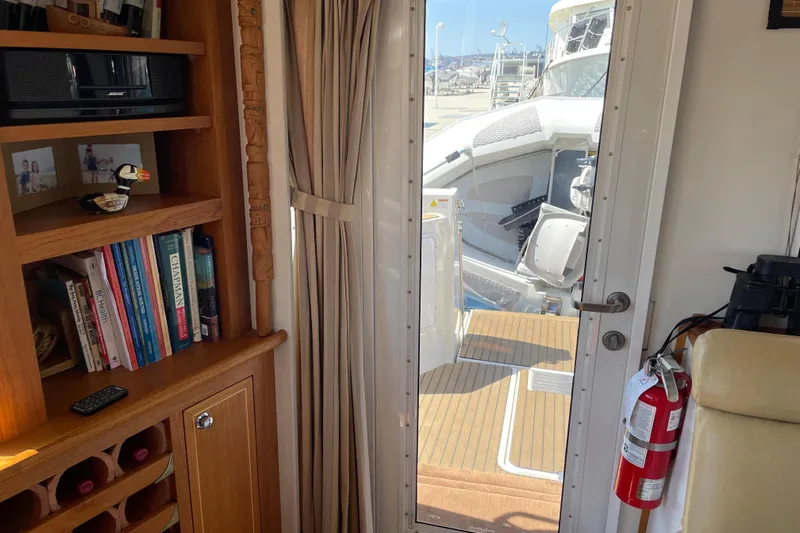  Yacht Photos Pics Interior of 2007 Fathom Yachts 40 with bookshelf, door to deck, and fire extinguisher.