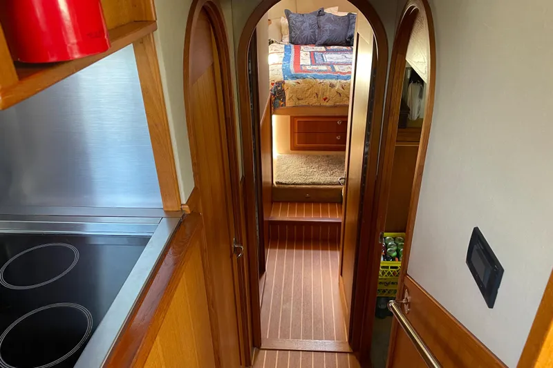  Yacht Photos Pics Interior of 2007 Fathom Yachts 40, featuring cozy bedroom and modern kitchen.