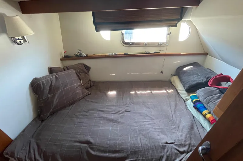  Yacht Photos Pics Cozy cabin interior of 2007 Fathom Yachts 40 with bed and window.