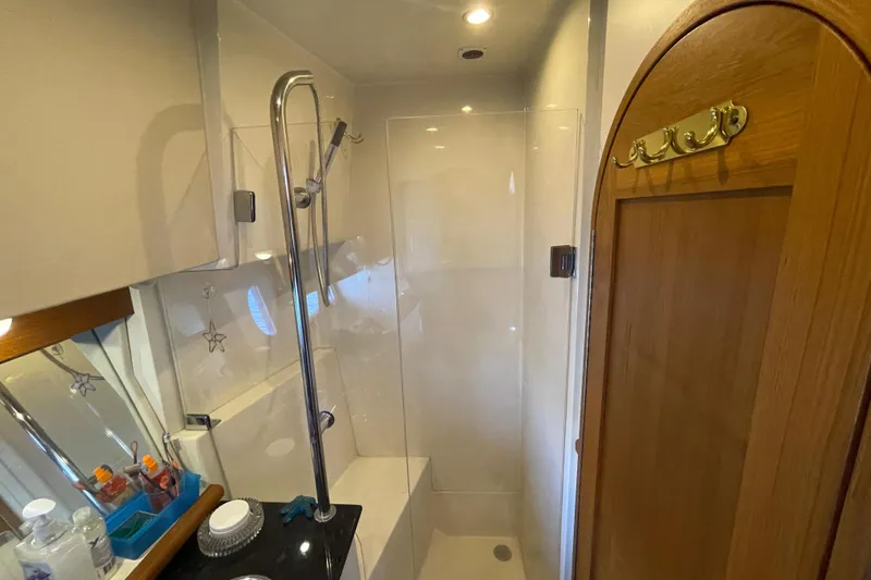  Yacht Photos Pics Bathroom interior of 2007 Fathom Yachts 40, featuring shower and wooden door.