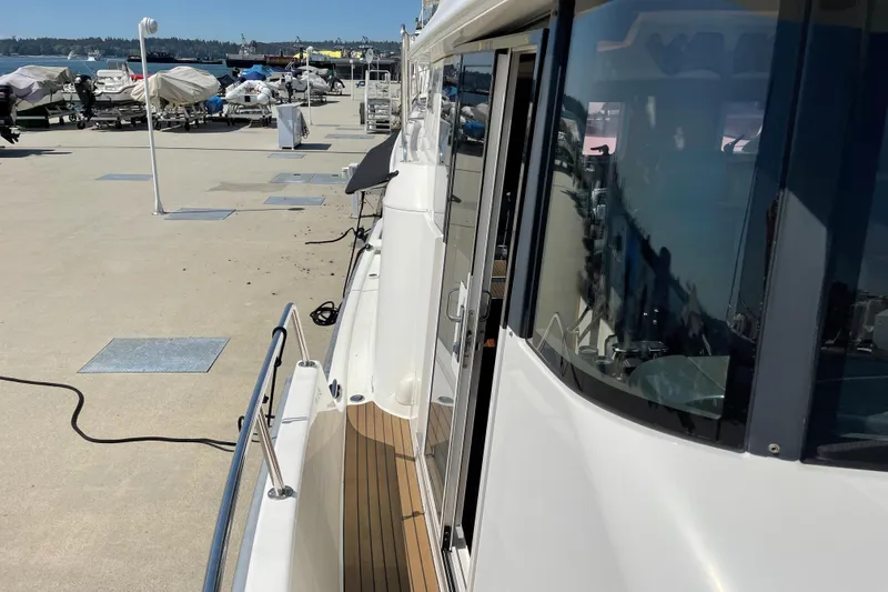  Yacht Photos Pics 2007 Fathom Yachts 40 docked, showcasing sleek design and wooden deck details.