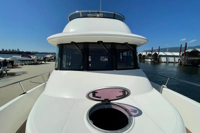  Yacht Photos Pics 2007 Fathom Yachts 40 docked, showcasing sleek design and spacious deck under clear blue sky.