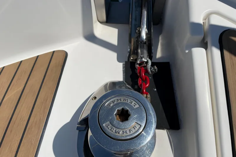  Yacht Photos Pics Anchor winch on 2007 Fathom Yachts 40, featuring teak decking and red chain.