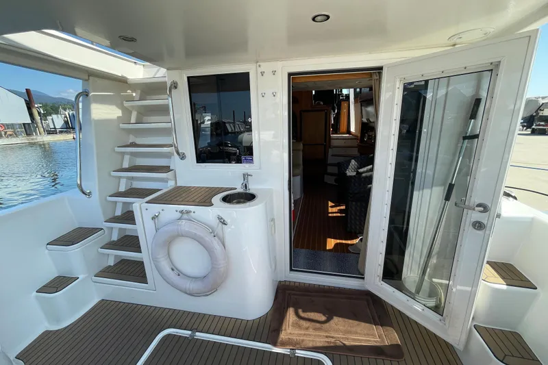  Yacht Photos Pics 2007 Fathom Yachts 40 interior view with stairs, door, and water access.