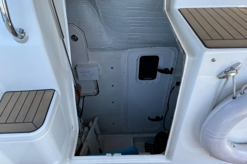  Yacht Photos Pics Engine room access on 2007 Fathom Yachts 40, featuring white interior and safety equipment.