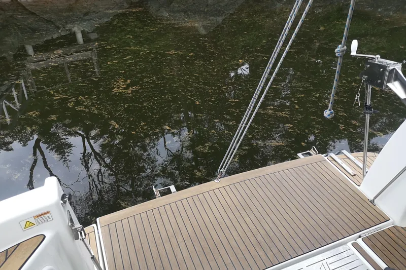  Yacht Photos Pics Teak deck of 2007 Fathom Yachts 40, reflecting trees in calm water.