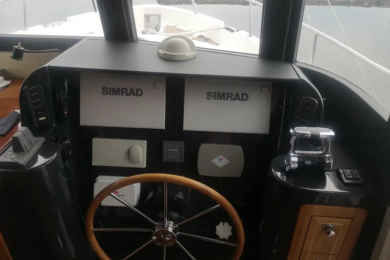 Yacht Photos Pics Helm of 2007 Fathom Yachts 40 with Simrad navigation equipment and wooden steering wheel.