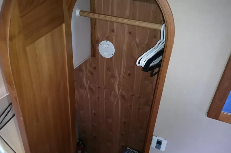  Yacht Photos Pics Wooden closet interior with hangers on a 2007 Fathom Yachts 40.