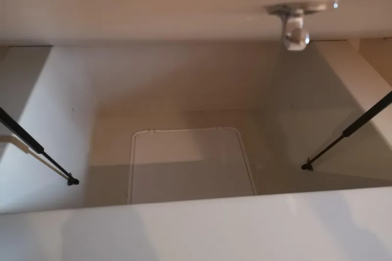  Yacht Photos Pics Storage compartment in 2007 Fathom Yachts 40, featuring hydraulic struts and latch mechanism.