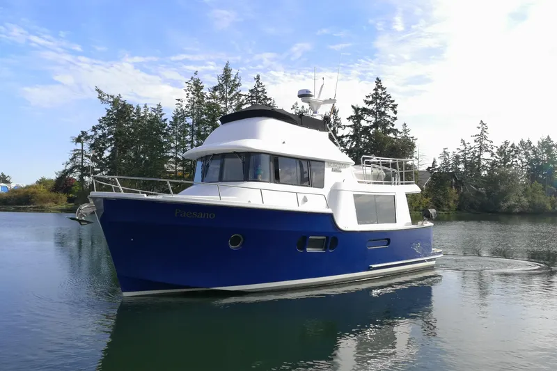  Yacht Photos Pics 2007 Fathom Yachts 40 cruising on a serene lake with forested background.
