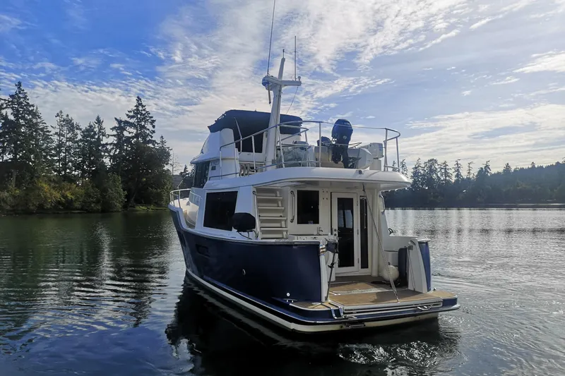  Yacht Photos Pics 2007 Fathom Yachts 40 on serene water with forested shoreline.