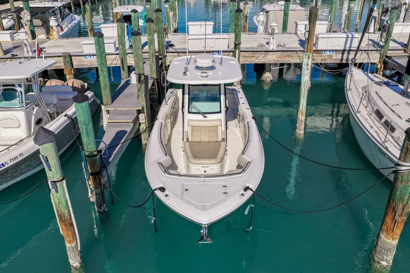  Yacht Photos Pics Boston Whaler 280 Outrage 2017 docked, surrounded by boats.