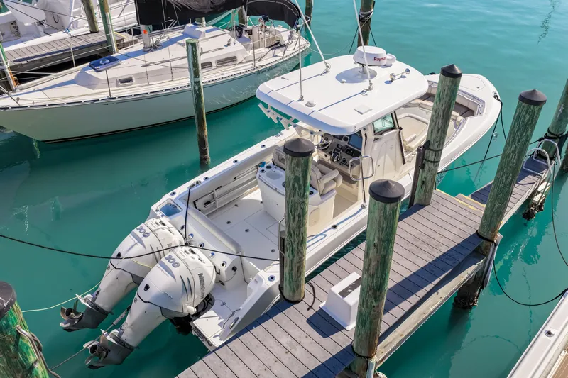  Yacht Photos Pics Boston Whaler 280 Outrage 2017 at dock, turquoise water.