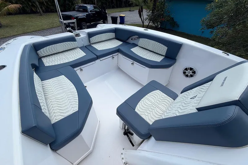  Yacht Photos Pics 2025 Twin Vee 260 GFX2 CC boat interior with blue and white cushioned seating.