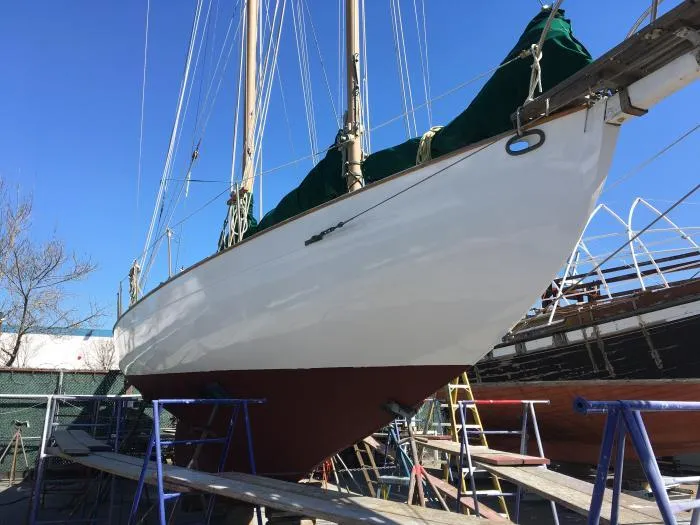 1927 Schock Staysail Schooner on dry dock, showcasing its sleek hull and classic design.