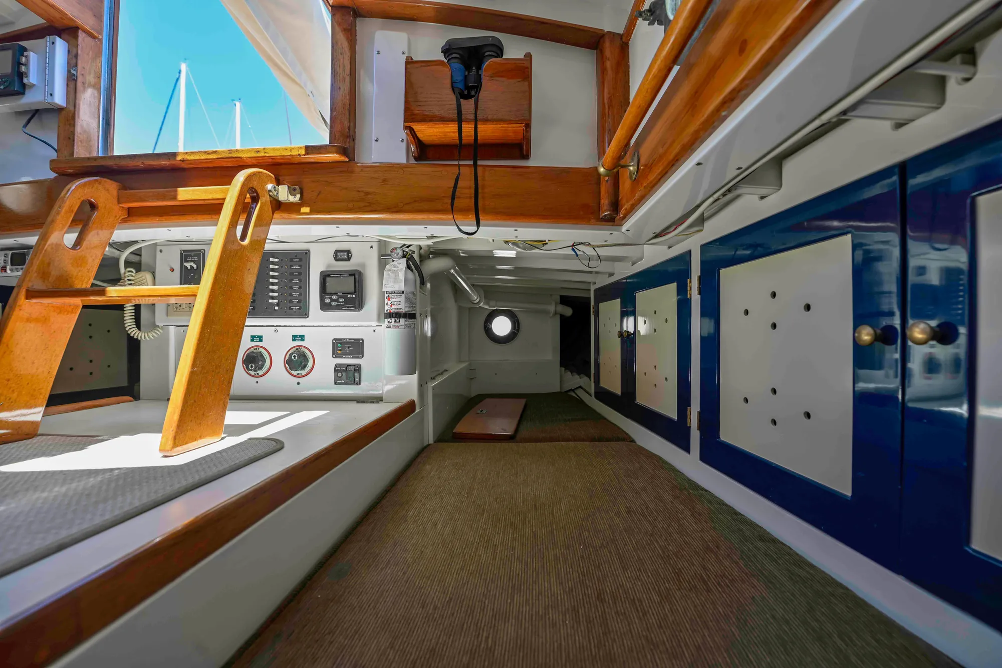 Interior of 1927 Schock Staysail Schooner, featuring wooden accents and nautical equipment.