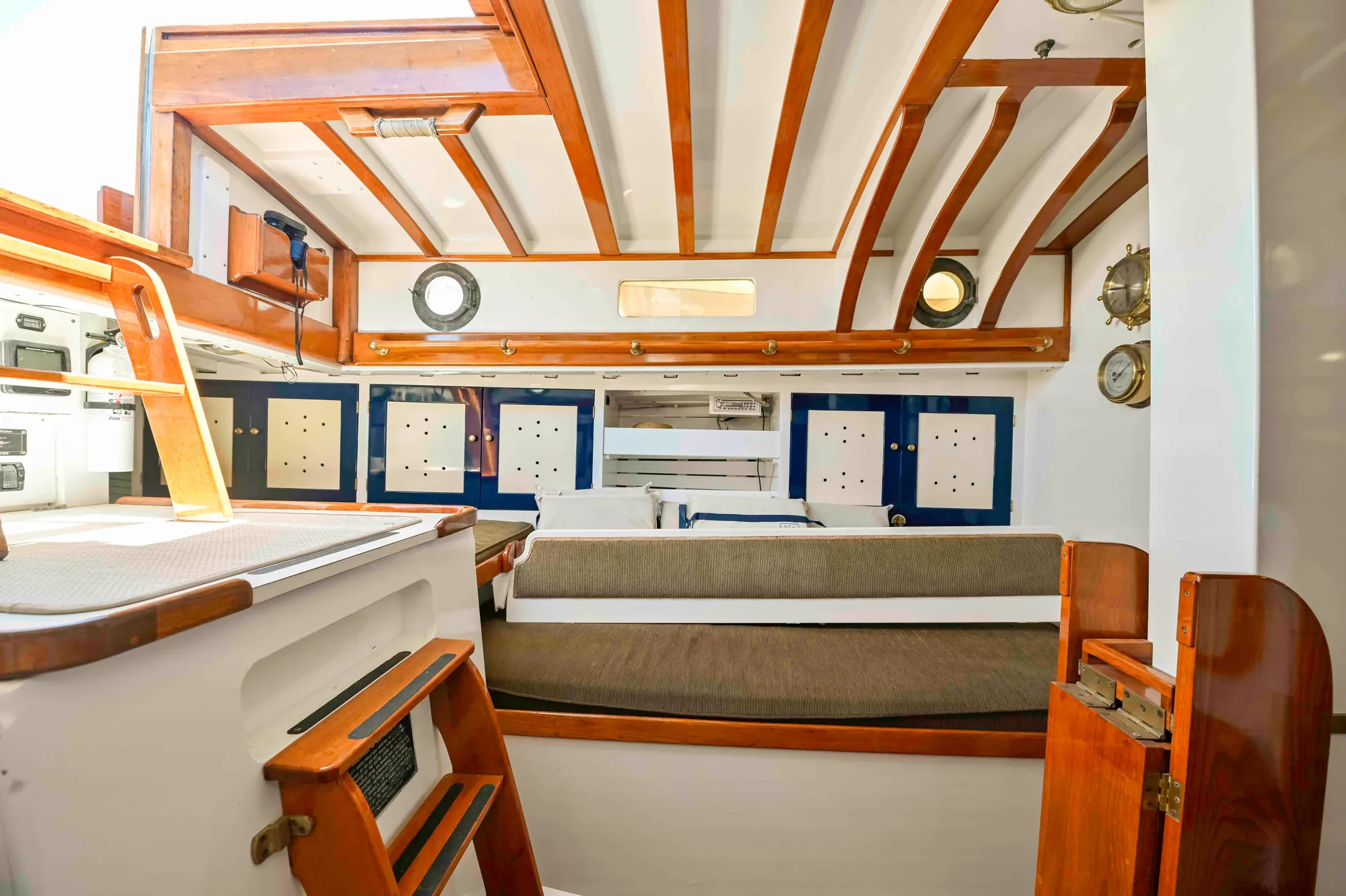 Interior of 1927 Schock Staysail Schooner with wooden beams and nautical decor.