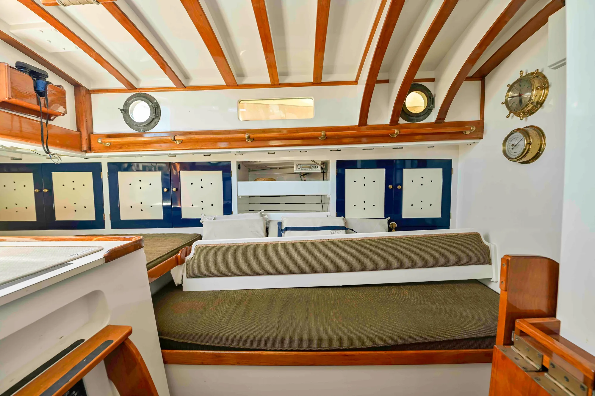 Interior of 1927 Schock Staysail Schooner with wooden beams and nautical decor.