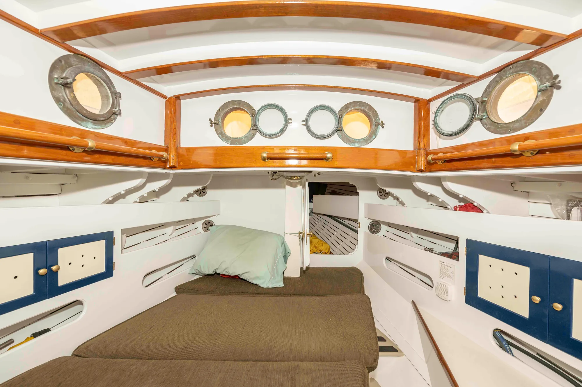 1927 Schock Staysail Schooner cabin interior with wooden beams and portholes.