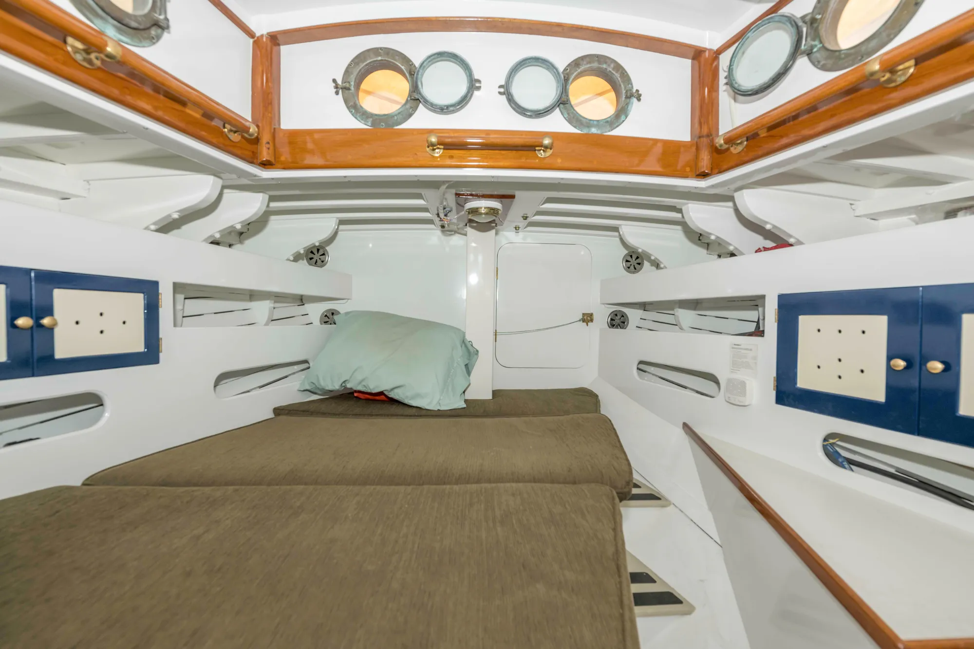 Interior cabin of 1927 Schock Staysail Schooner with cozy bunks and portholes.