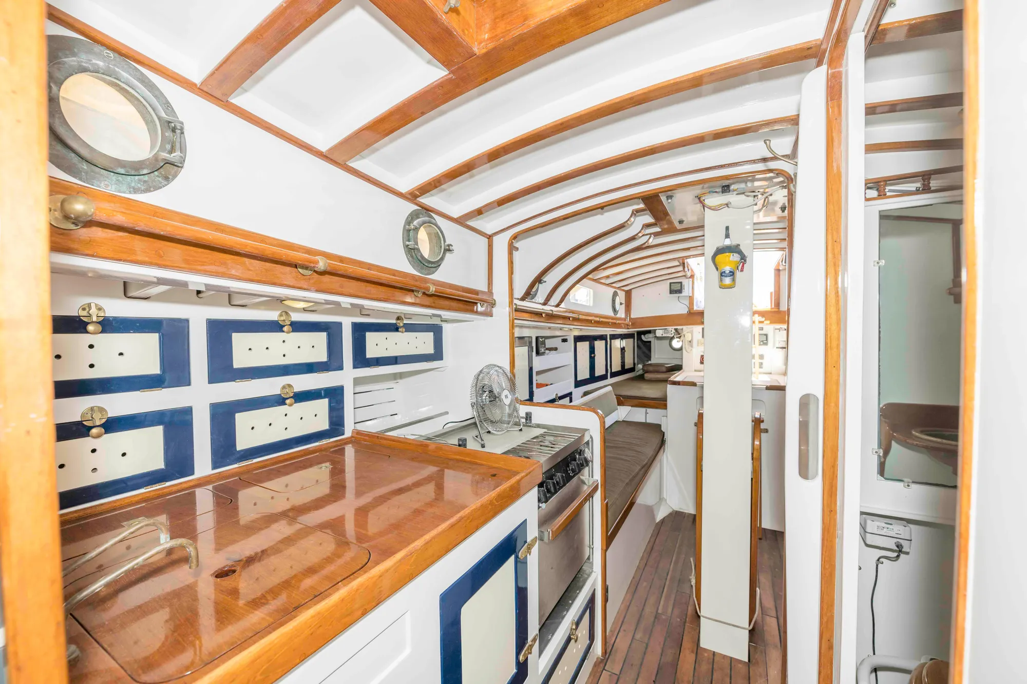 Interior of 1927 Schock Staysail Schooner with wooden cabinetry and nautical design.
