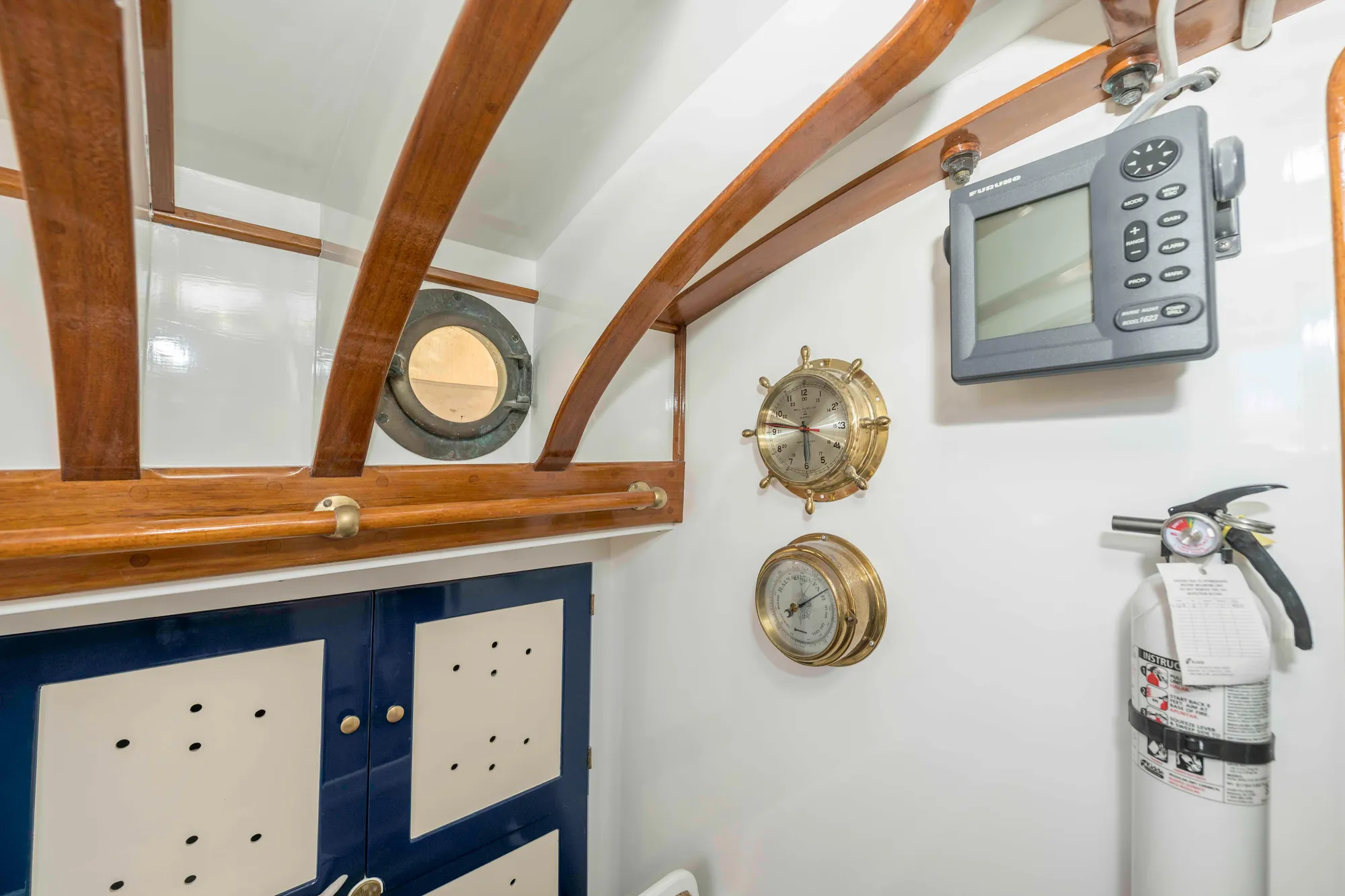 Interior of 1927 Schock Staysail Schooner with nautical instruments and fire extinguisher.