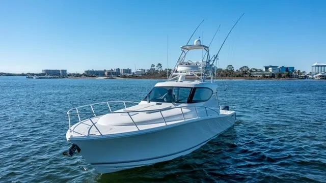  Yacht Photos Pics 2015 Jupiter 41 SB boat on calm water, clear sky, cityscape background.