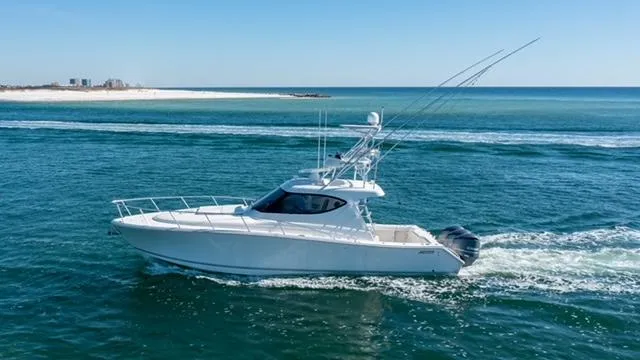  Yacht Photos Pics 2015 Jupiter 41 SB yacht cruising on open sea near sandy coastline.